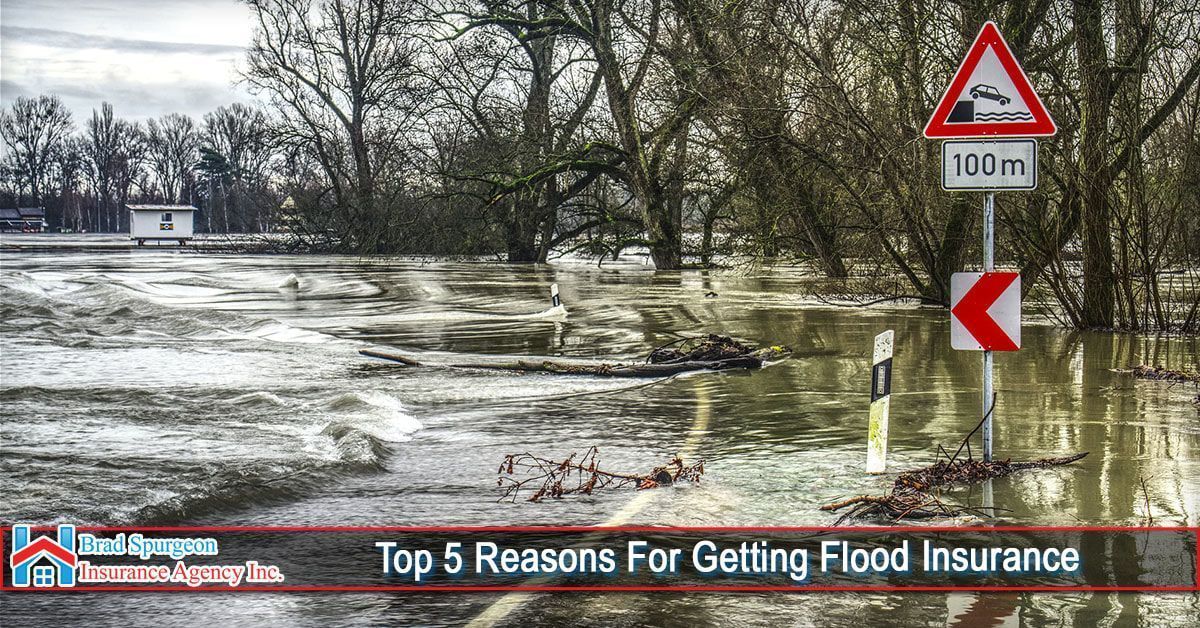 A flooded road with road signs