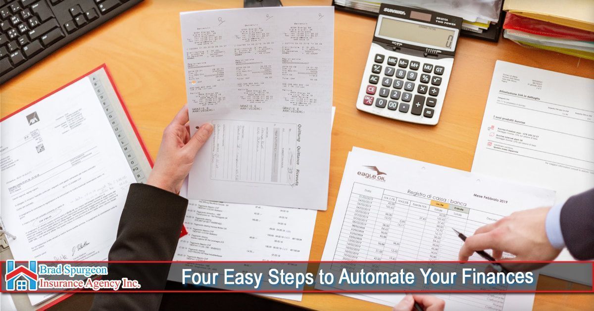 Two people at a desk reviewing financial documents and a calculator,