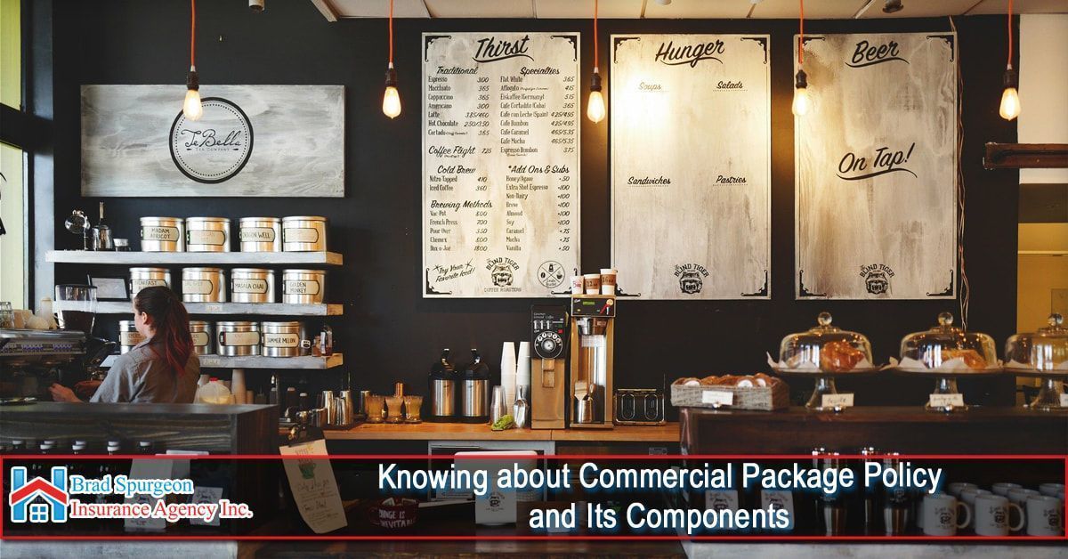 A brightly lit cafe interior with menu boards on a dark wall, a service counter