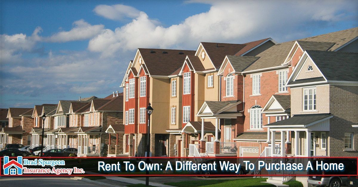 A row of brick and stucco townhomes under a blue sky