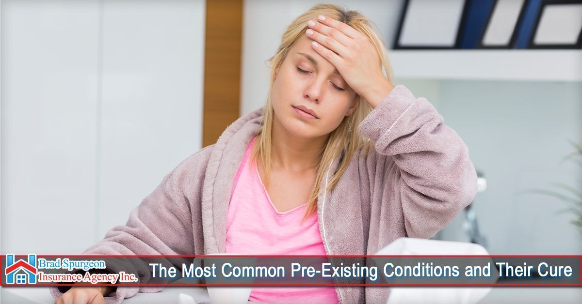 A person in a pink shirt and robe looking ill with a hand on their forehead
