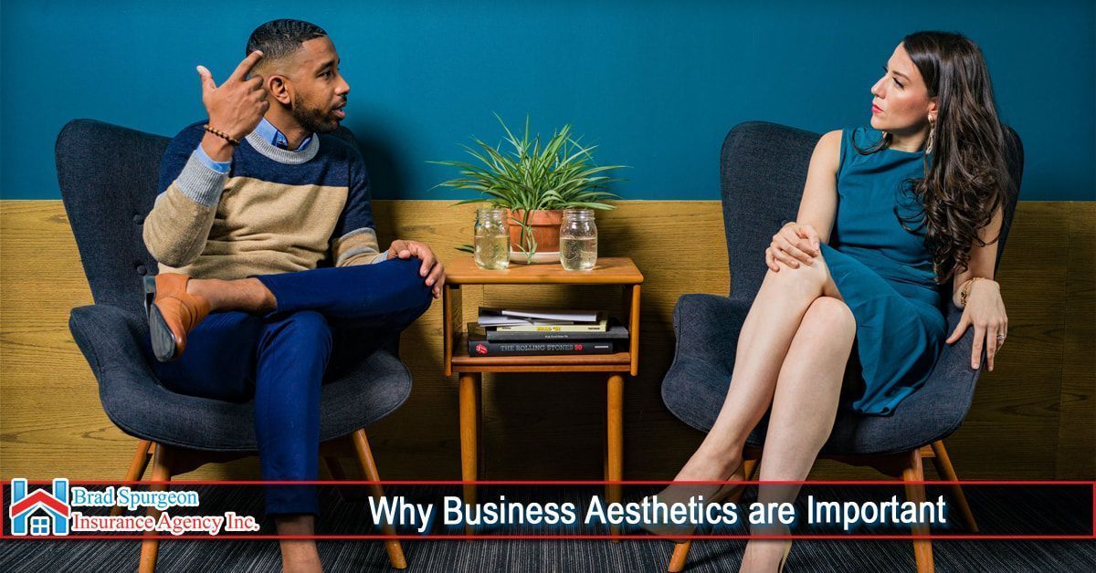 Two people in a modern office, sitting in armchairs and talking