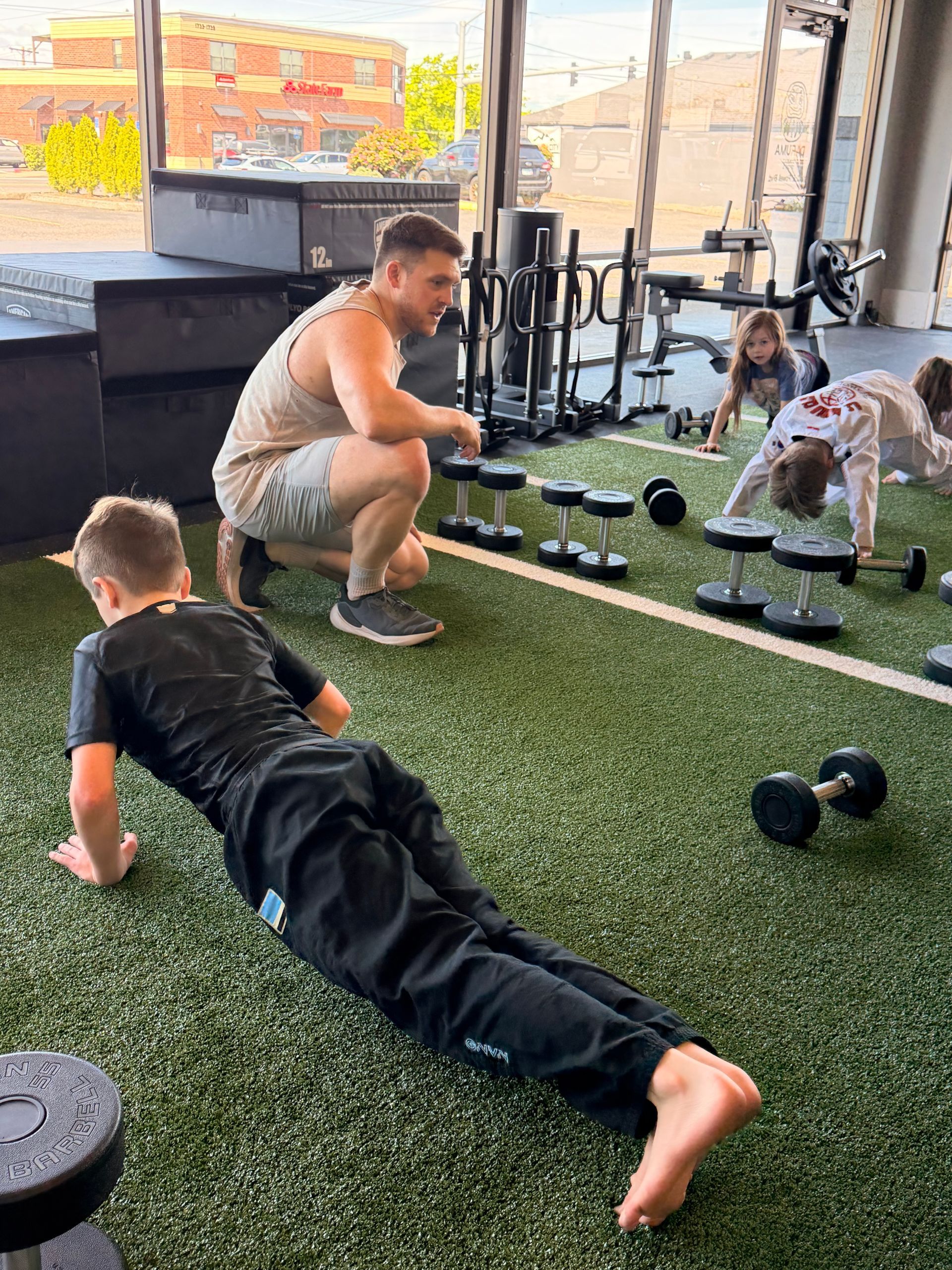 Adults and children training together in a group gym session