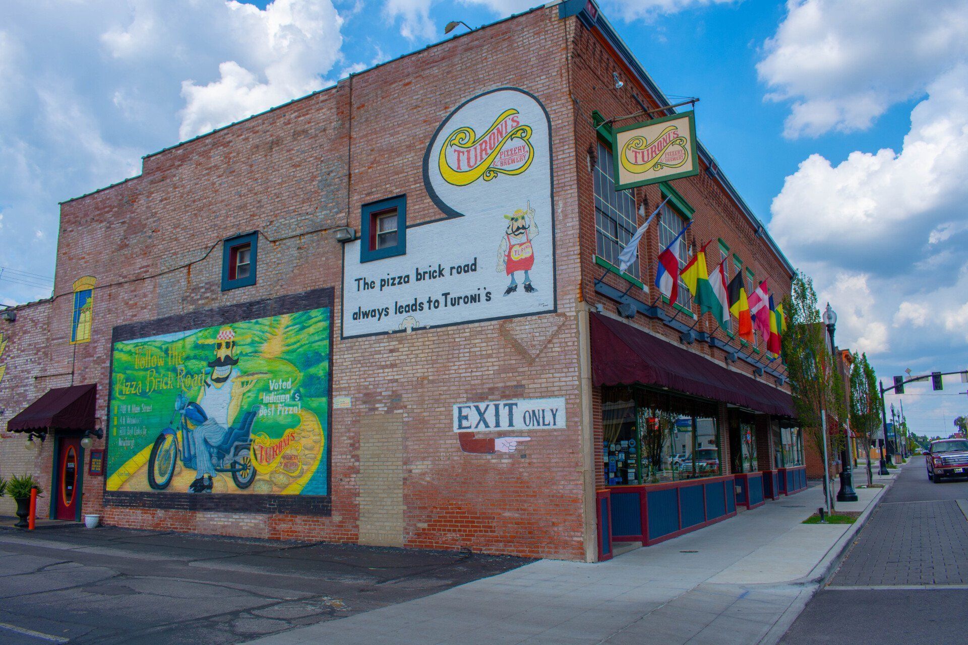 A brick building with a sign that says exit on it
