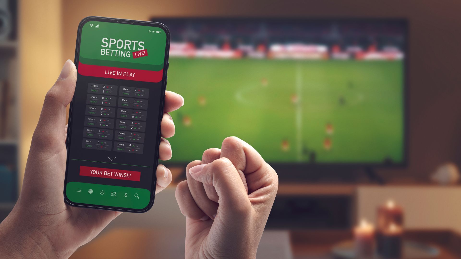 A person is holding a cell phone with a sports betting app on it.
