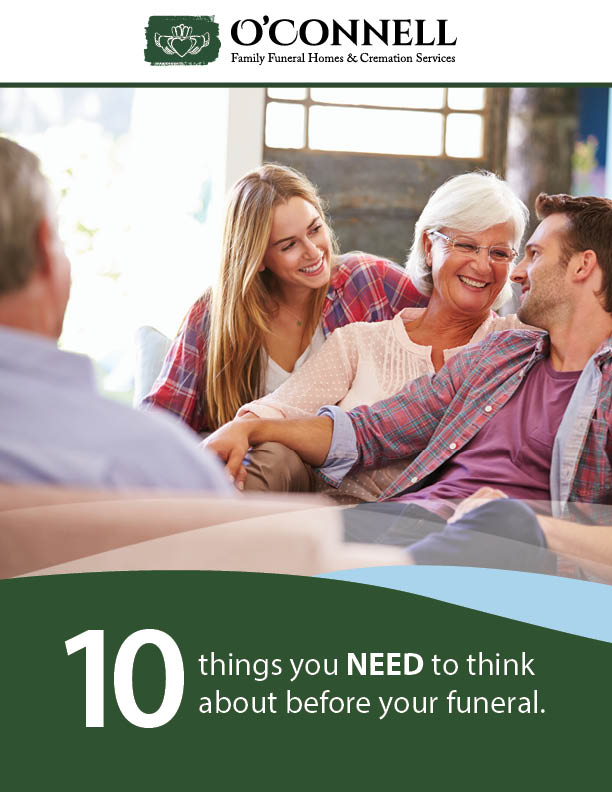 A family is sitting on a couch talking to each other.