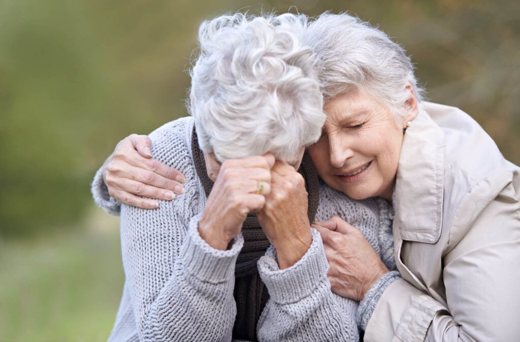 A woman is comforting an older woman who is crying.