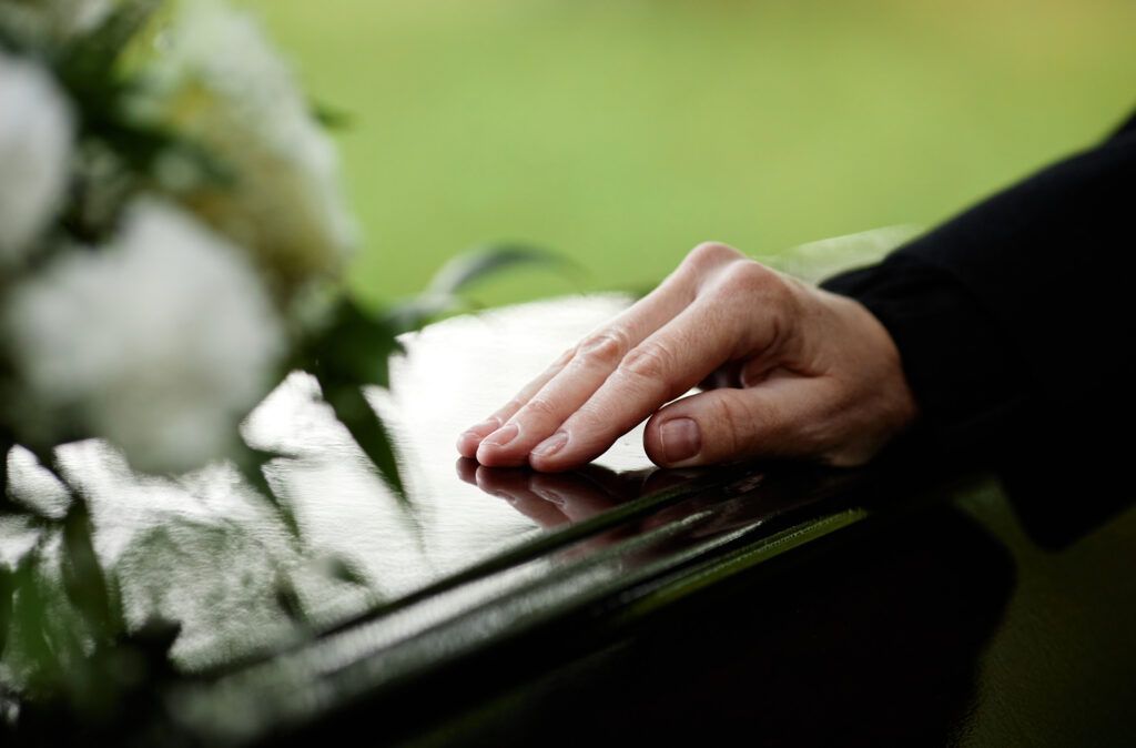 A close up of a person 's hand on a piano keyboard.