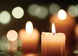 A group of lit candles are sitting on a table