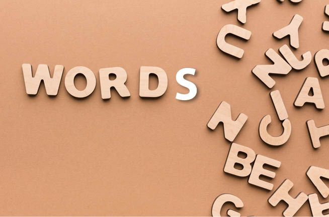 The word words is written in wooden letters on a brown background