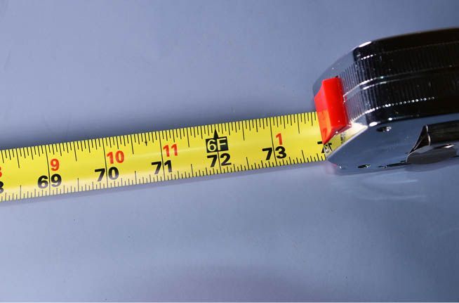 A close up of a tape measure with the number 73 on it