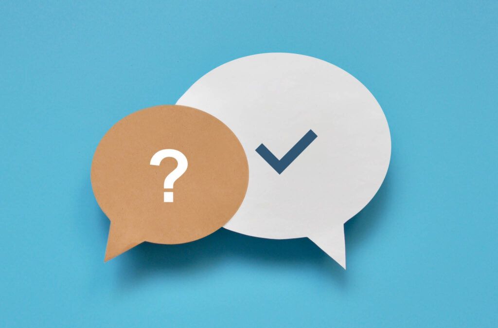 Two speech bubbles with a question mark and a check mark on a blue background.