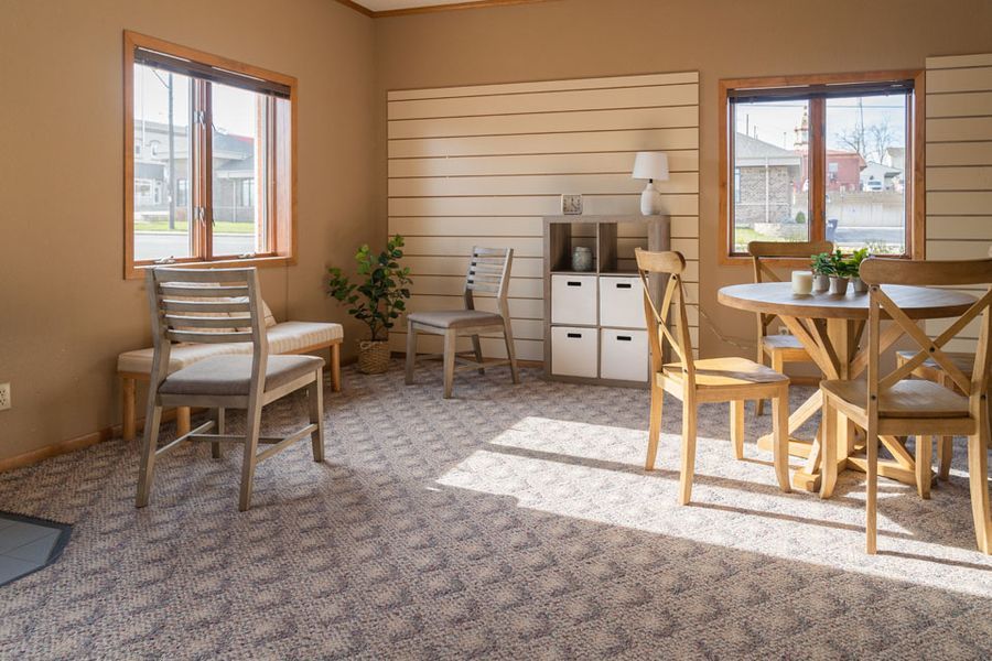A living room with a table and chairs in it at O’Connell Family Funeral Homes