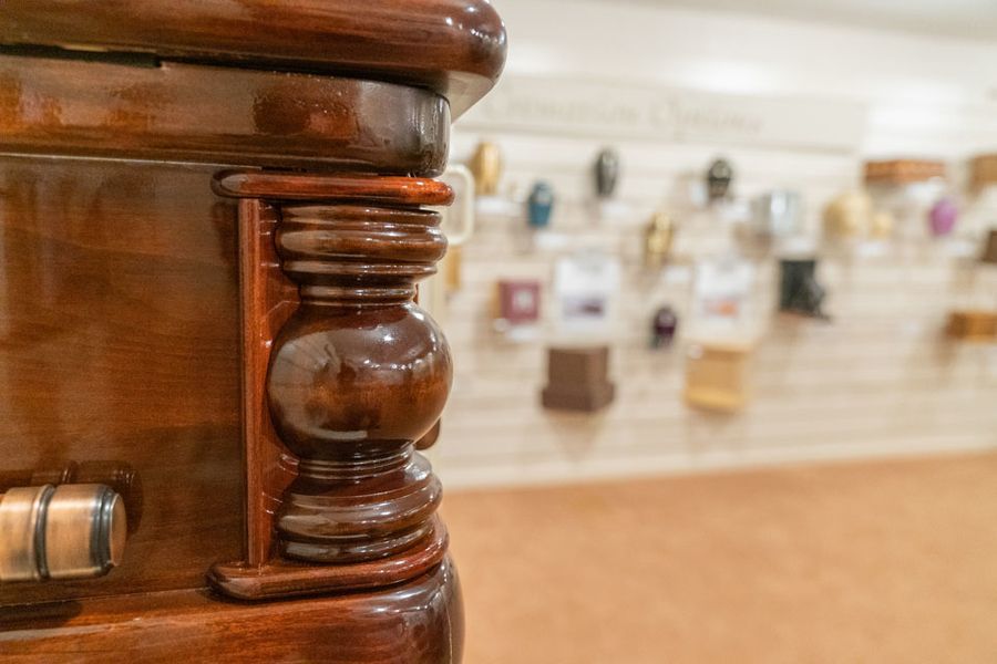A close up of a wooden coffin in a room.
