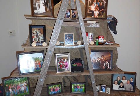 A wooden ladder filled with pictures of a family