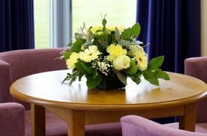 A table with a vase of flowers on it