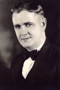 A black and white photo of a man in a tuxedo