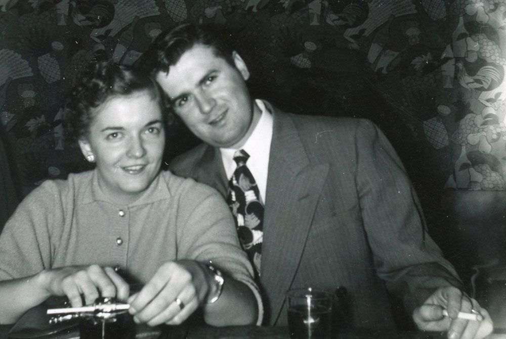 A black and white photo of a man and woman sitting at a table