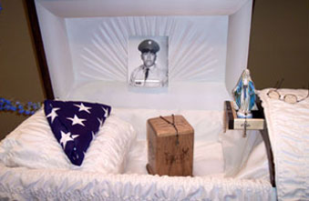 A coffin with a picture of a man in a uniform on the top of it.