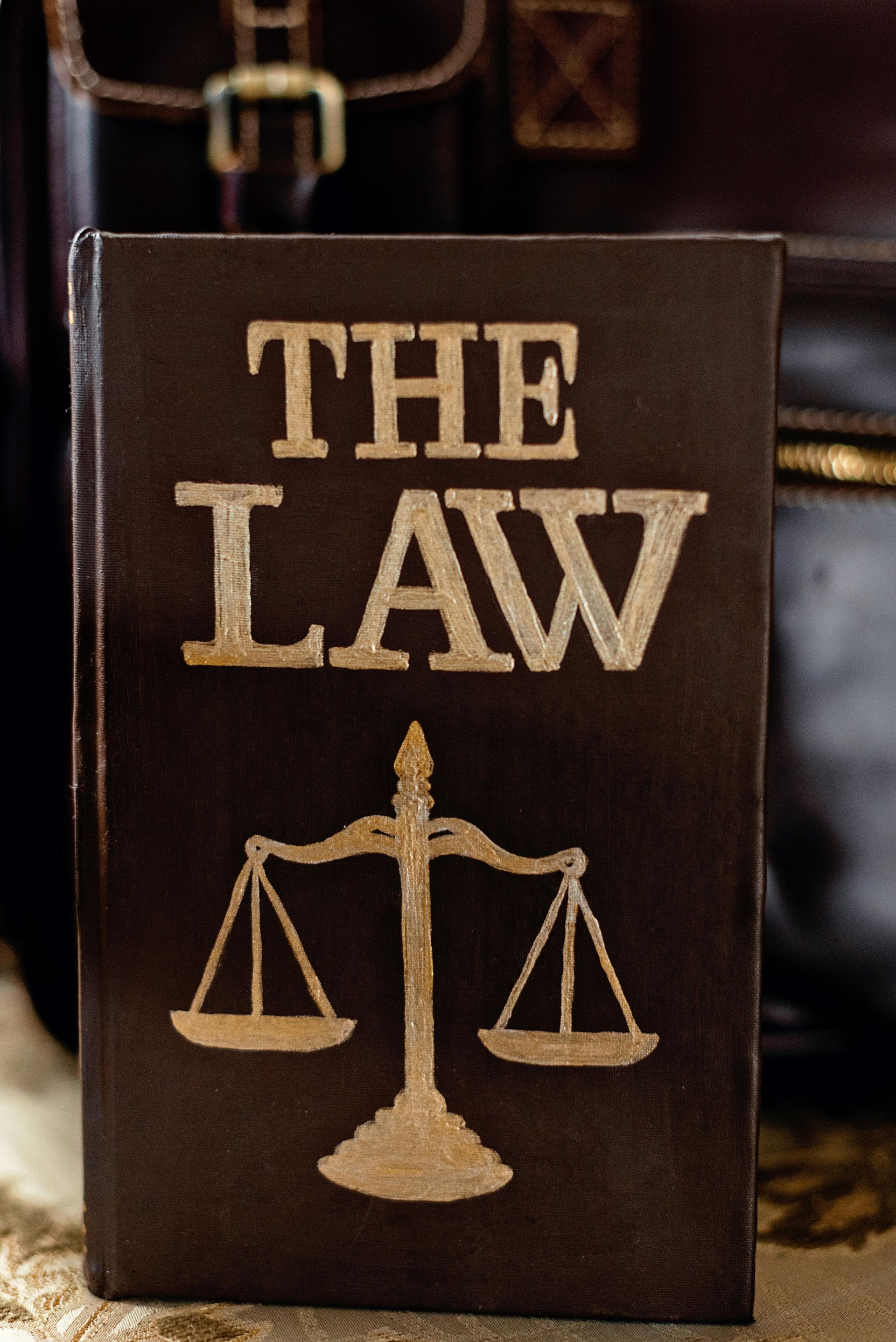 A judge 's gavel is sitting on a wooden table.