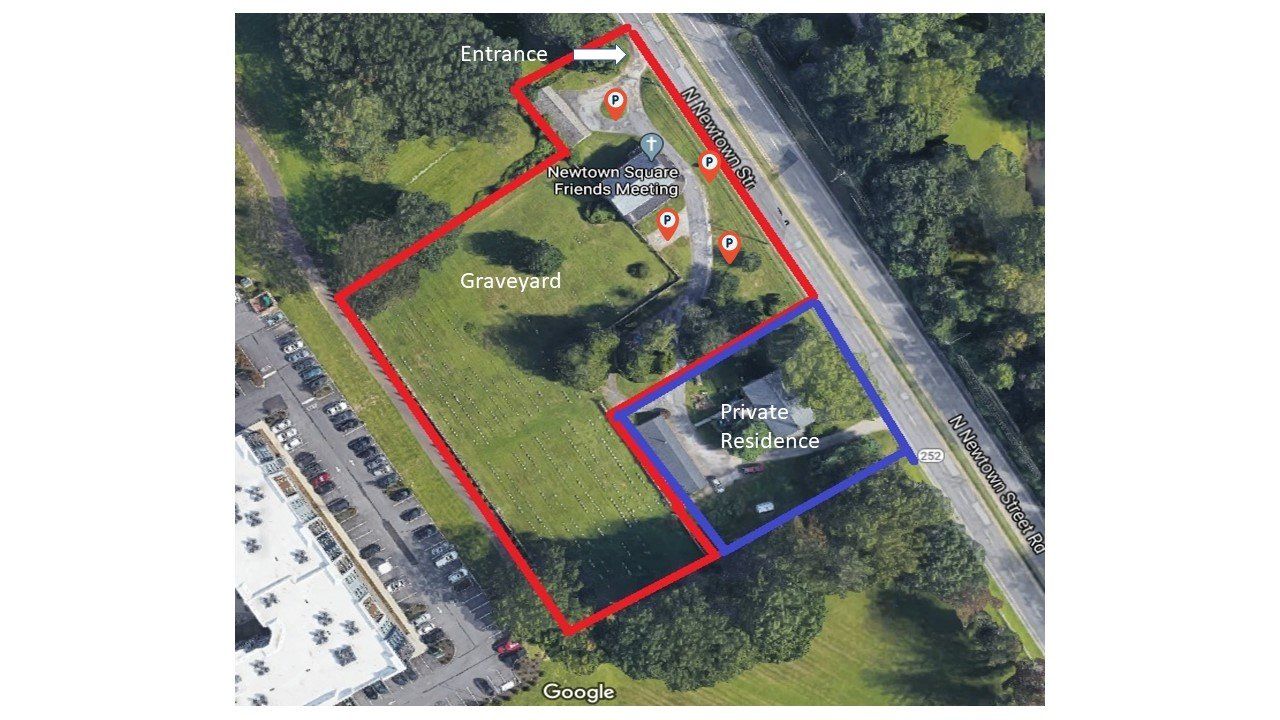 Aerial view of two properties outlined in red and blue. The red property contains Meeting and graveyard.