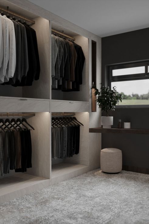 Built-in closet with hanging clothes, shelves, a window, and a small desk in a modern bedroom.