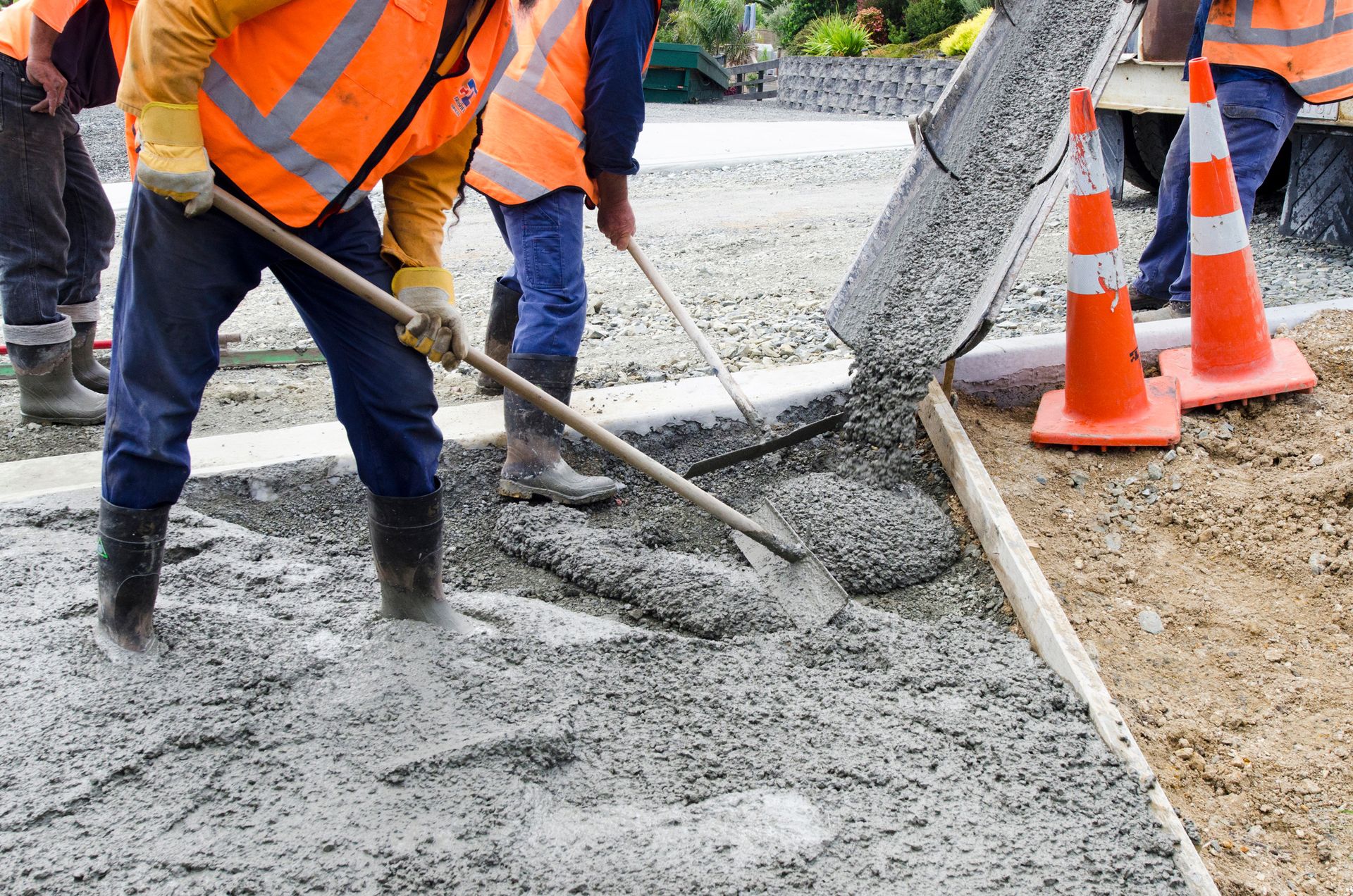 A group of construction workers are working on a road.