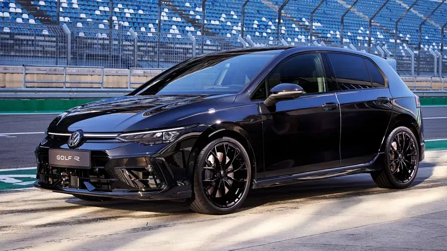 Black Volkswagen Golf R parked on a racetrack.