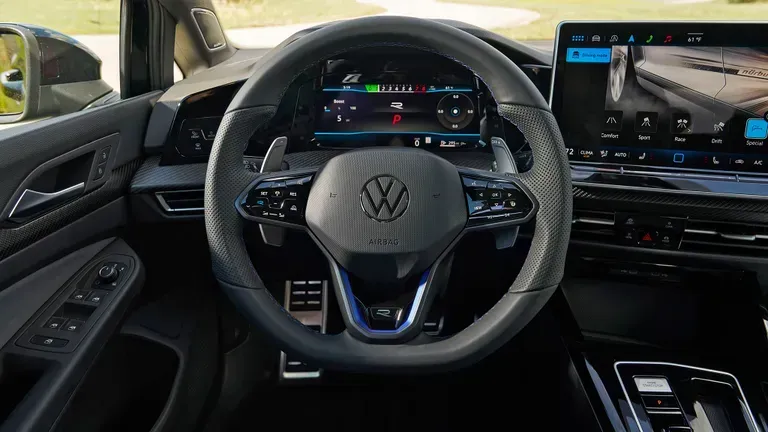 The interior view of a Volkswagen vehicle, focusing on the steering wheel, digital dashboard, and center touchscreen.