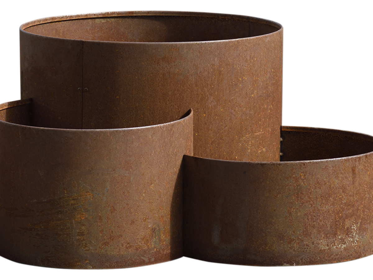 Three rusted cylindrical metal planters of varying heights.