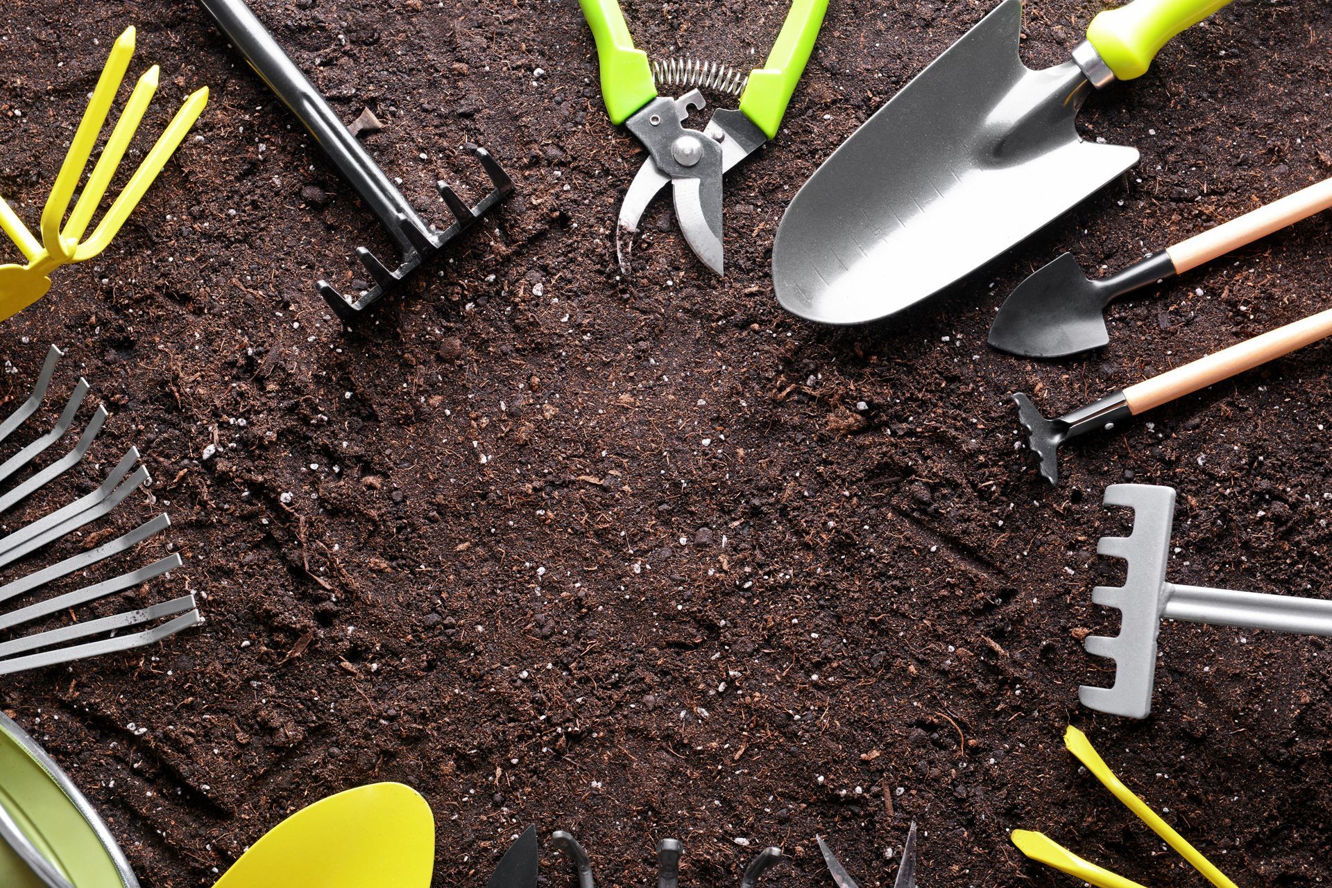 Set of gardening equipment on soil.