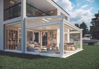 Casa moderna con patio coperto da una pergola bianca e posti a sedere all'aperto su un prato verde.