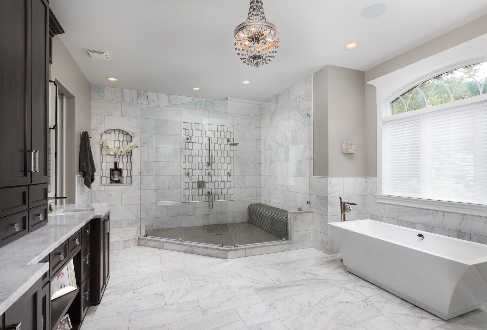 A bathroom with a bathtub and a walk in shower.
