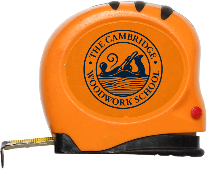 Bright orange tape measure with a logo for The Cambridge Woodwork School printed on its side.