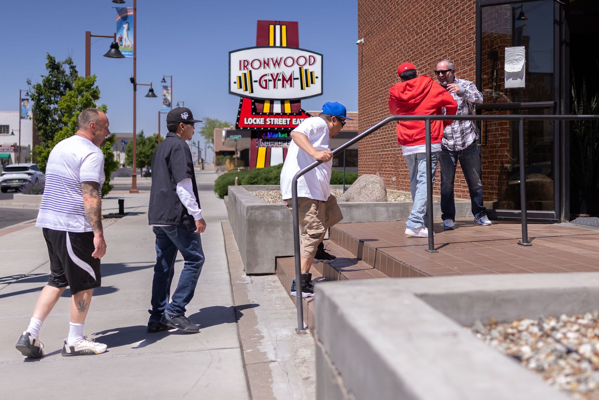 Ironwood Gym and Locke Street Eats roadside sign with red, yellow, and white panels, plus a “Now Open” notice