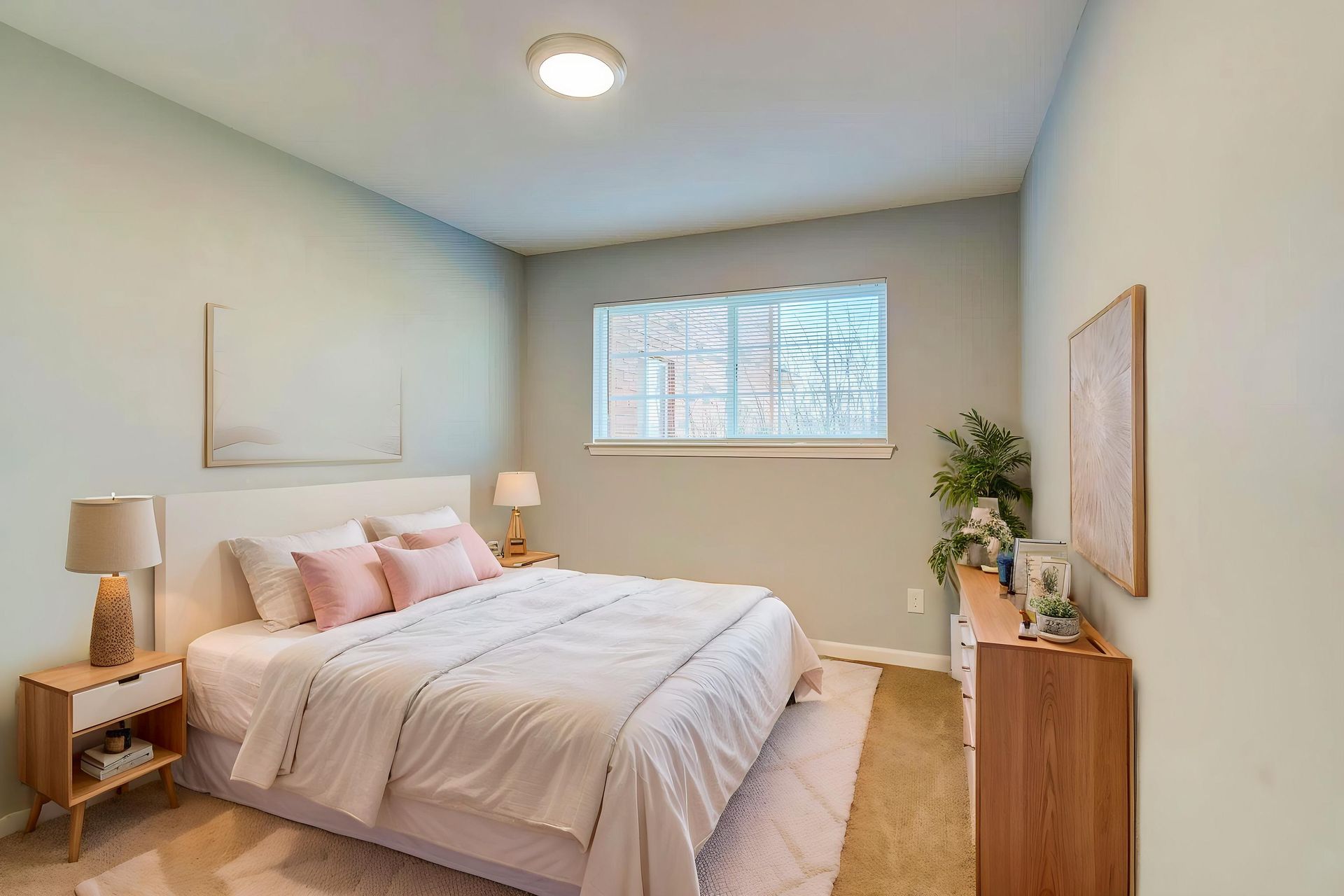 An empty bedroom with a ceiling fan and a window.