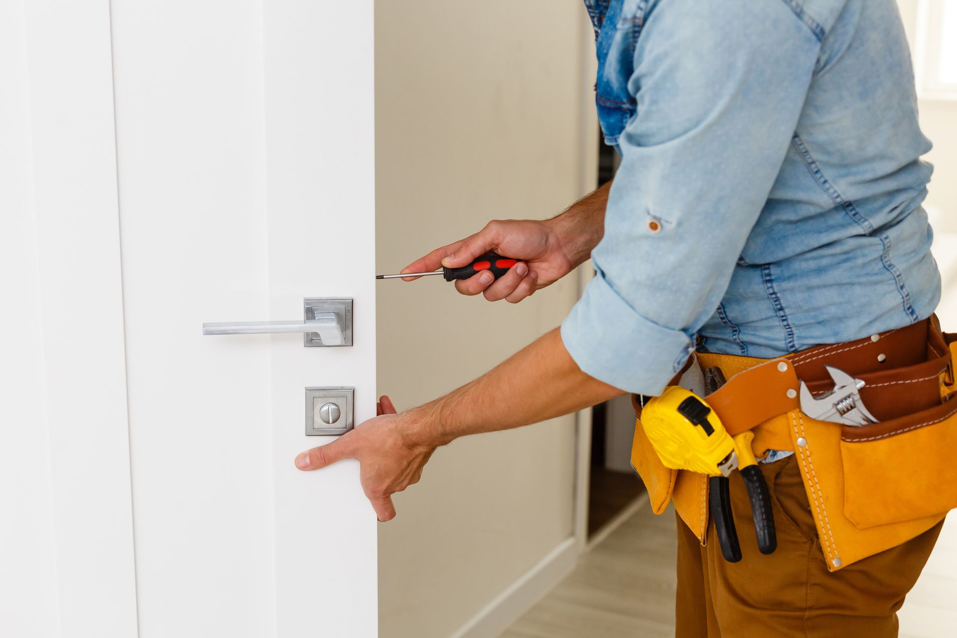 Man Checking the Door Lock — St. Louis Park, MN — Registered Locksmiths