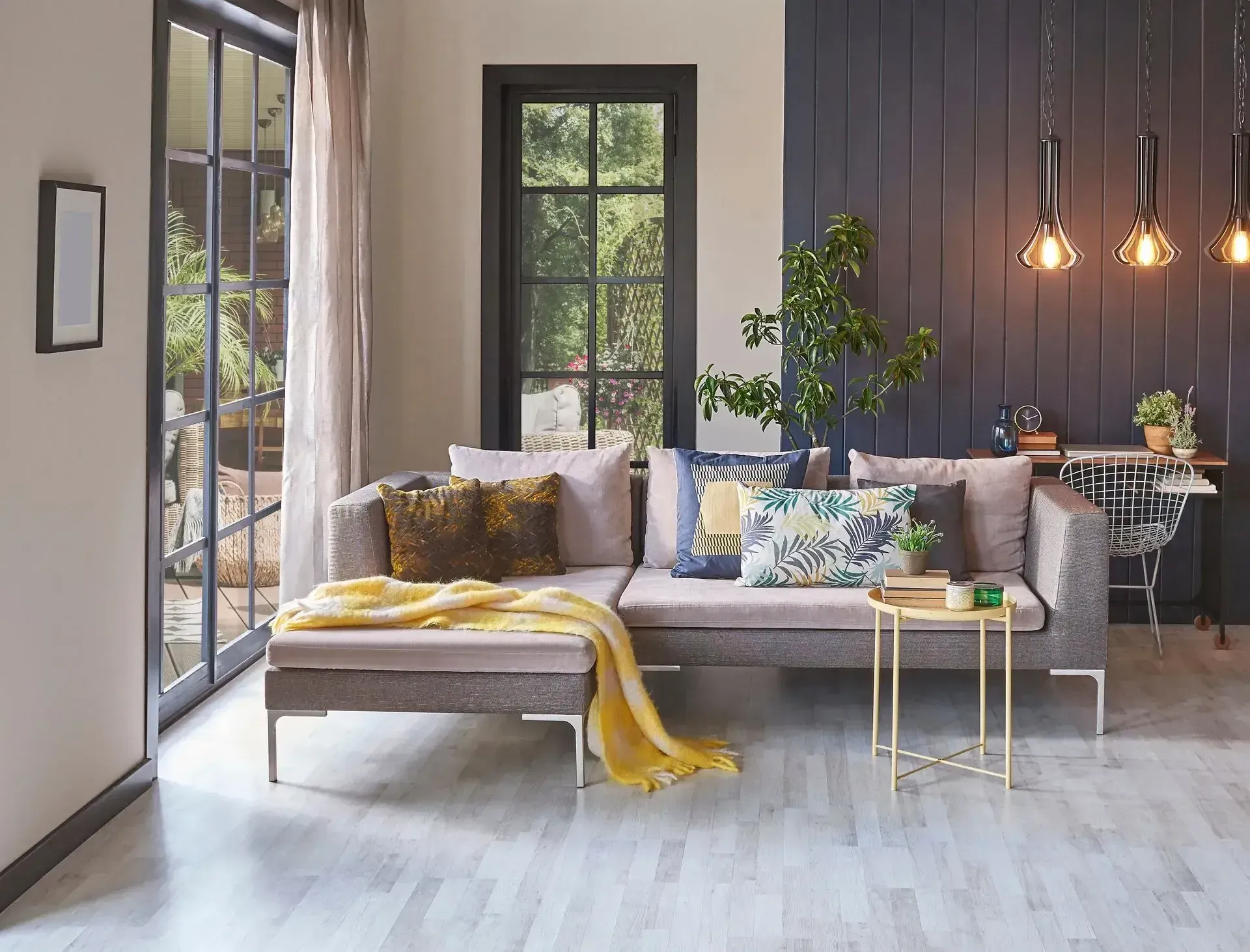 a living room with a couch , table , and window .