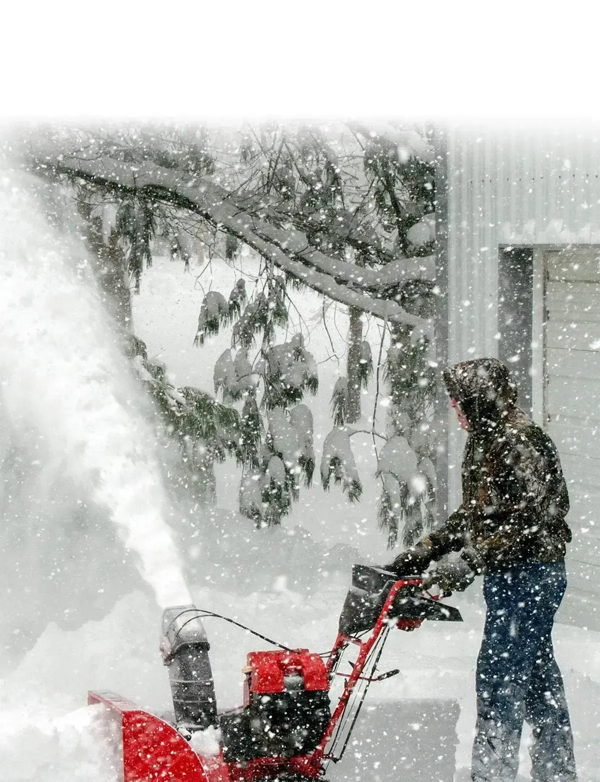 Man Removing Snow with a Machine