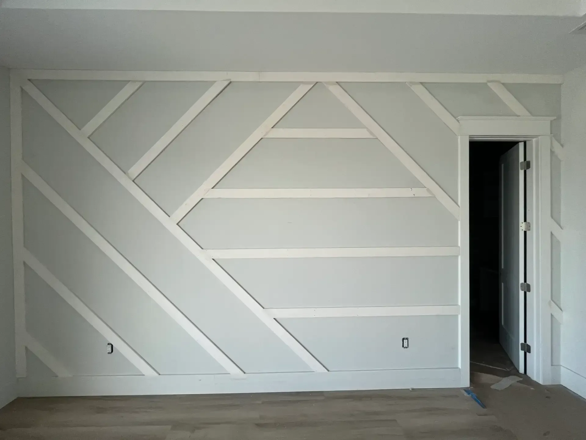 Geometric diamond accent wall with custom trim design
