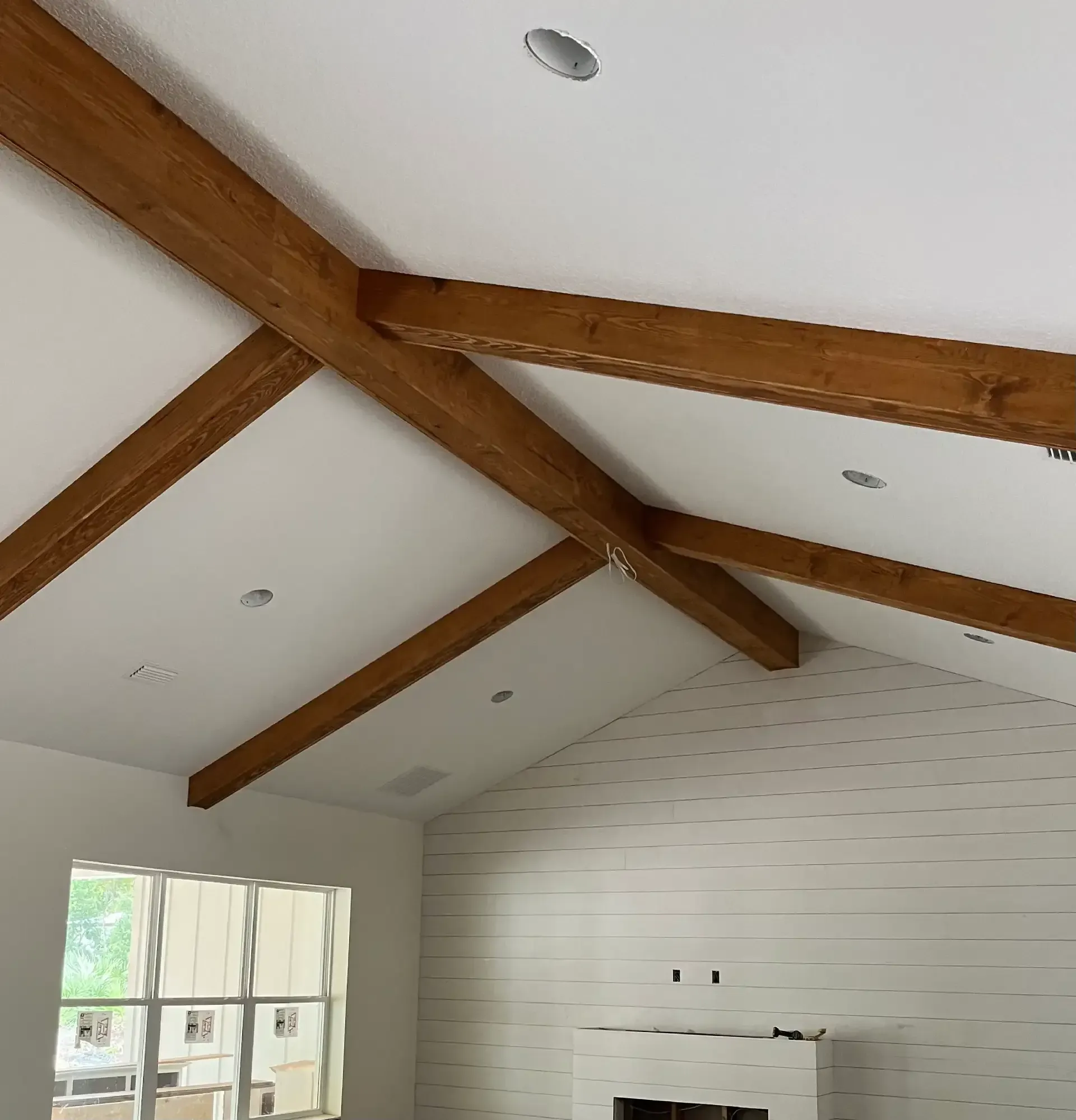 Exposed wood beams on vaulted ceiling
