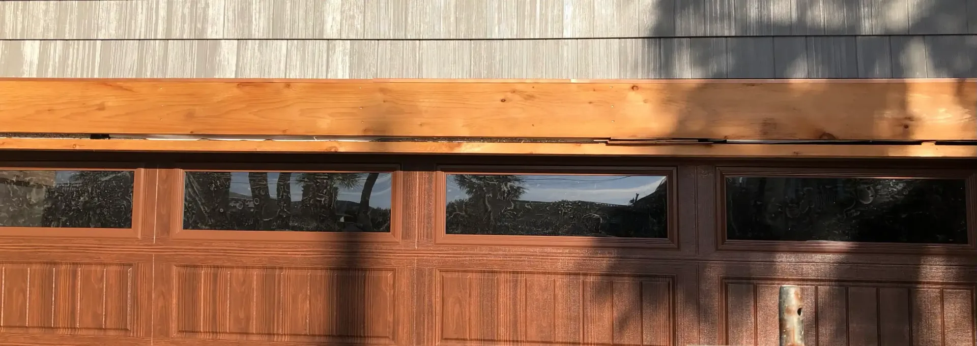 Wood trim detail above garage door with windows