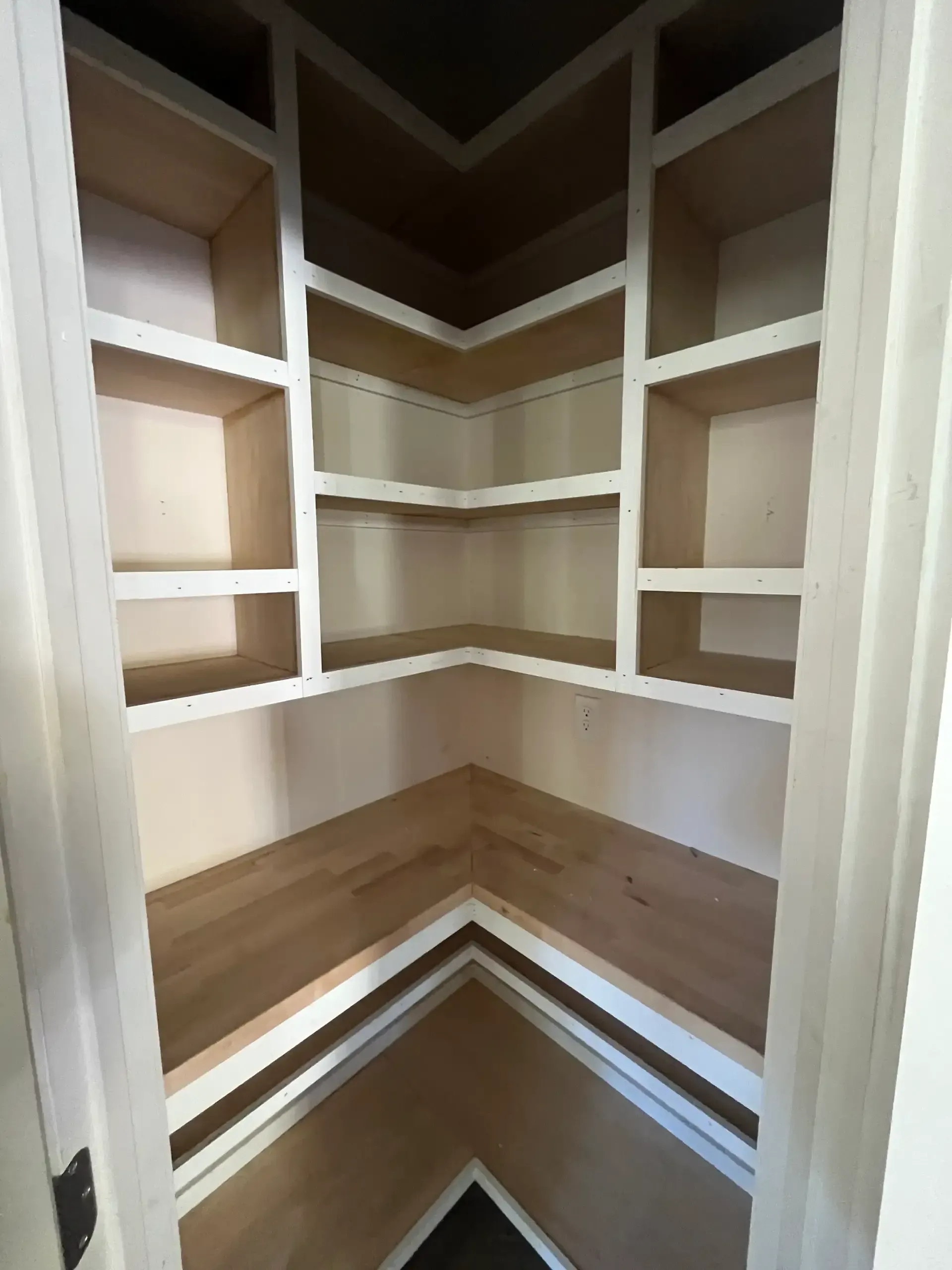 Custom pantry with built-in wood shelves and storage