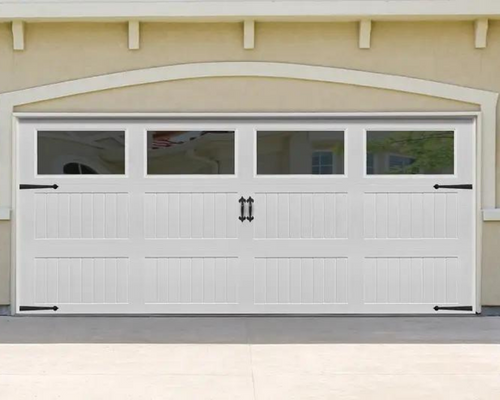 White garage door with four windows on a beige house exterior