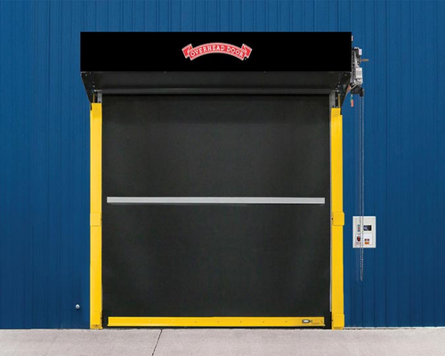 Industrial loading dock door with black and yellow frame on a blue corrugated wall