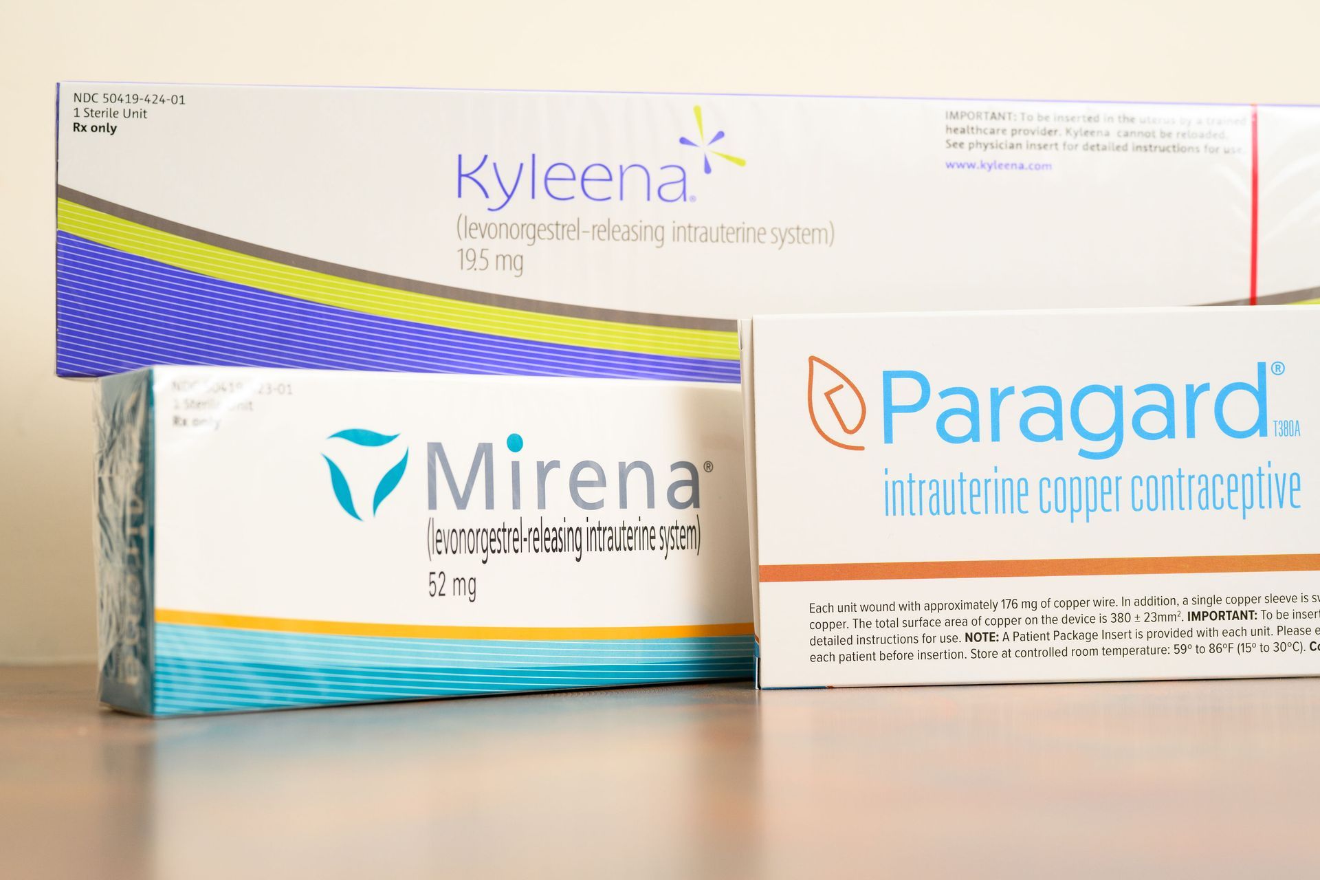 Three different packages of intrauterine devices (IUDs): Kyleena, Mirena, and Paragard.