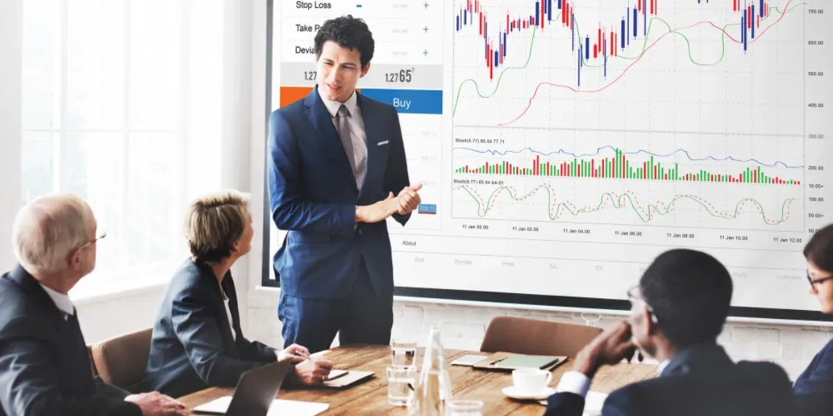 A man is giving a presentation to a group of people in a conference room.
