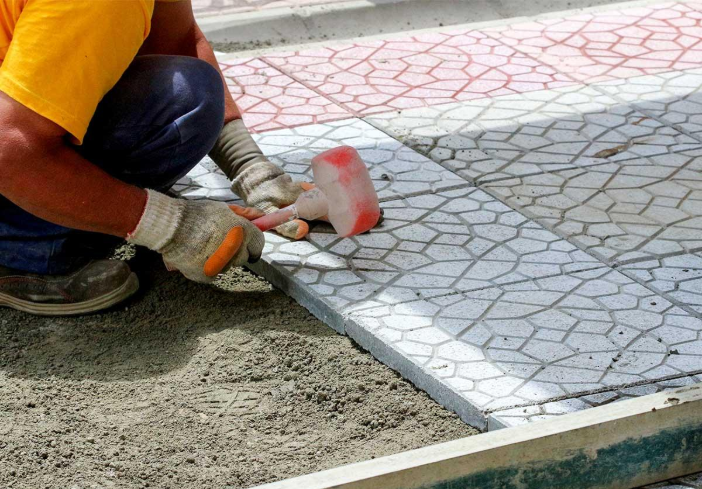 Close-up of interlocking concrete pavers laid in a herringbone pattern for a Four Corners FL patio