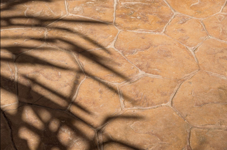 Stamped concrete surface imprinted with a stone pattern and integral color on a Four Corners FL patio