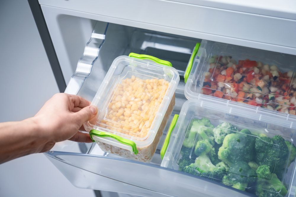 Person Holding Refrigerator Door — Ace Fridge Door Seals In Cairns, QLD
